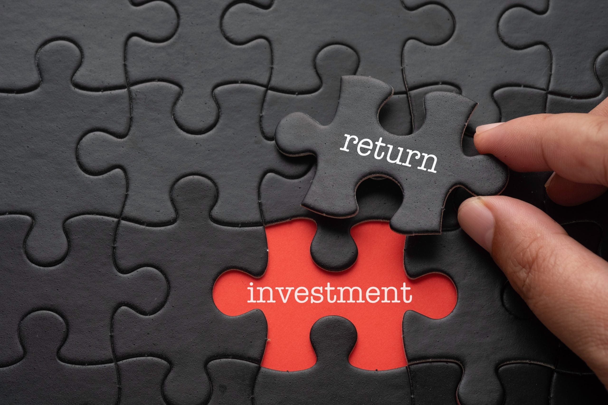 A person placing a piece of a puzzle with the words "return investment" and "expungement.