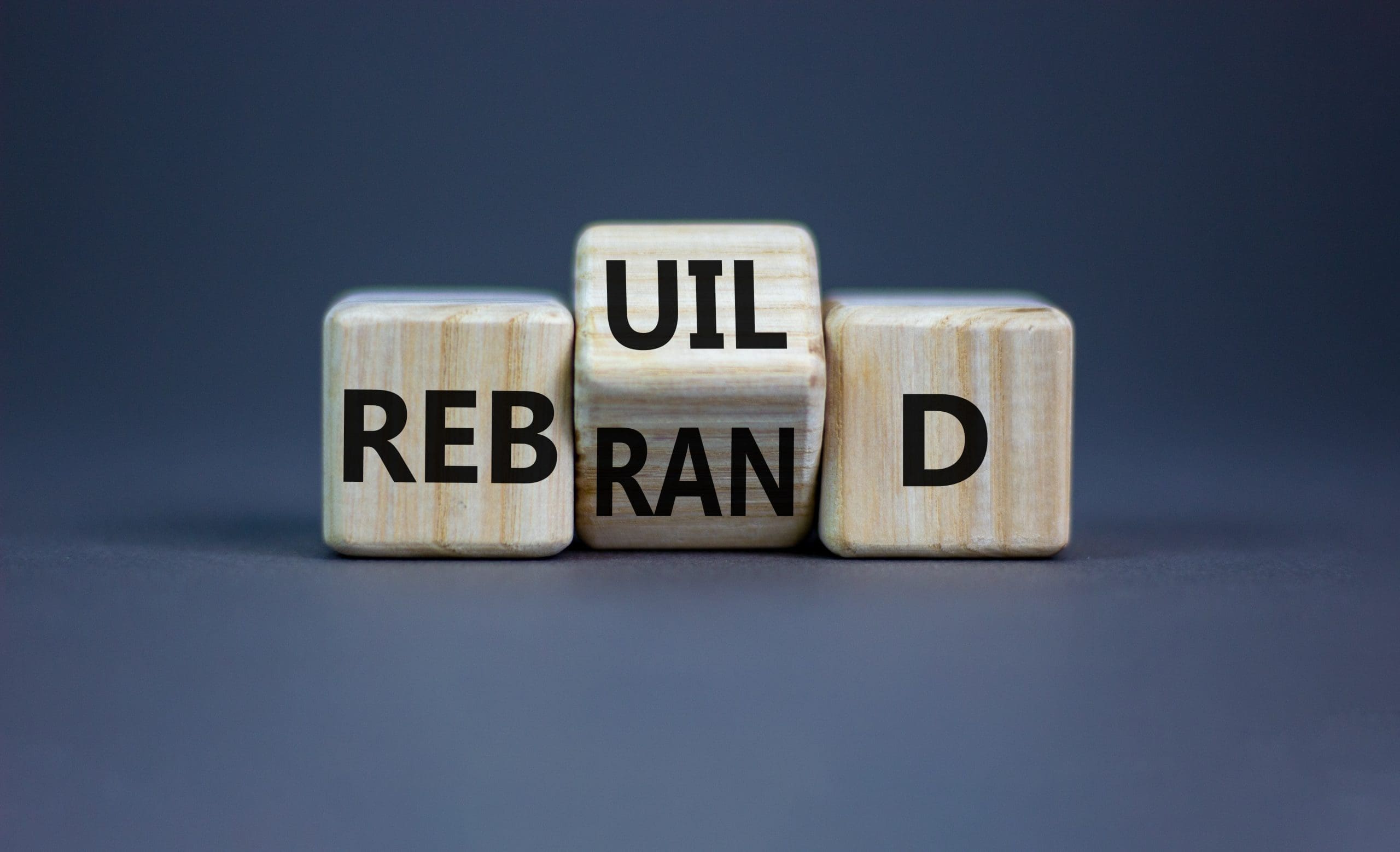A set of wooden cubes with the words ul rebrand d.