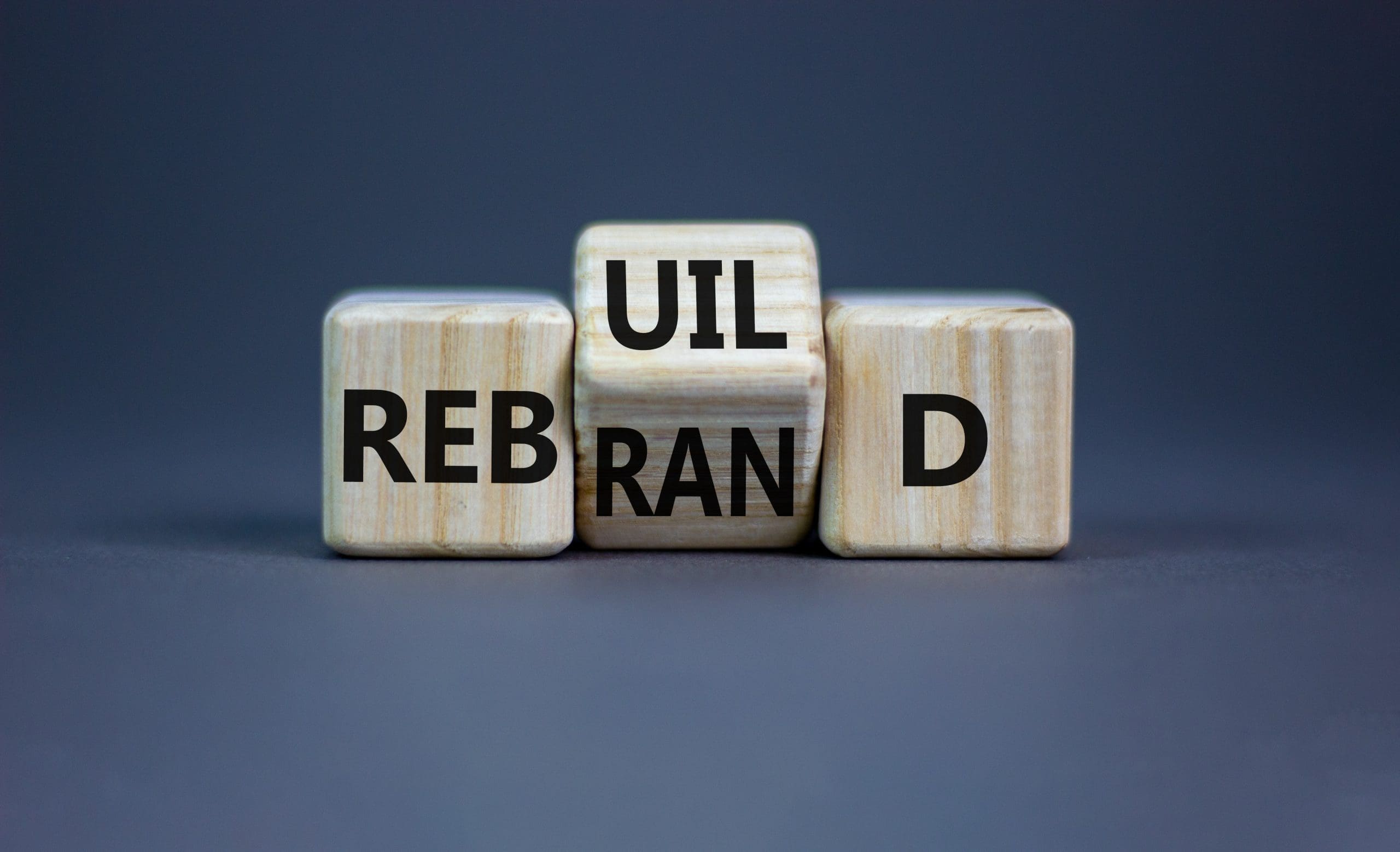 A set of wooden cubes with the words ul rebrand d.