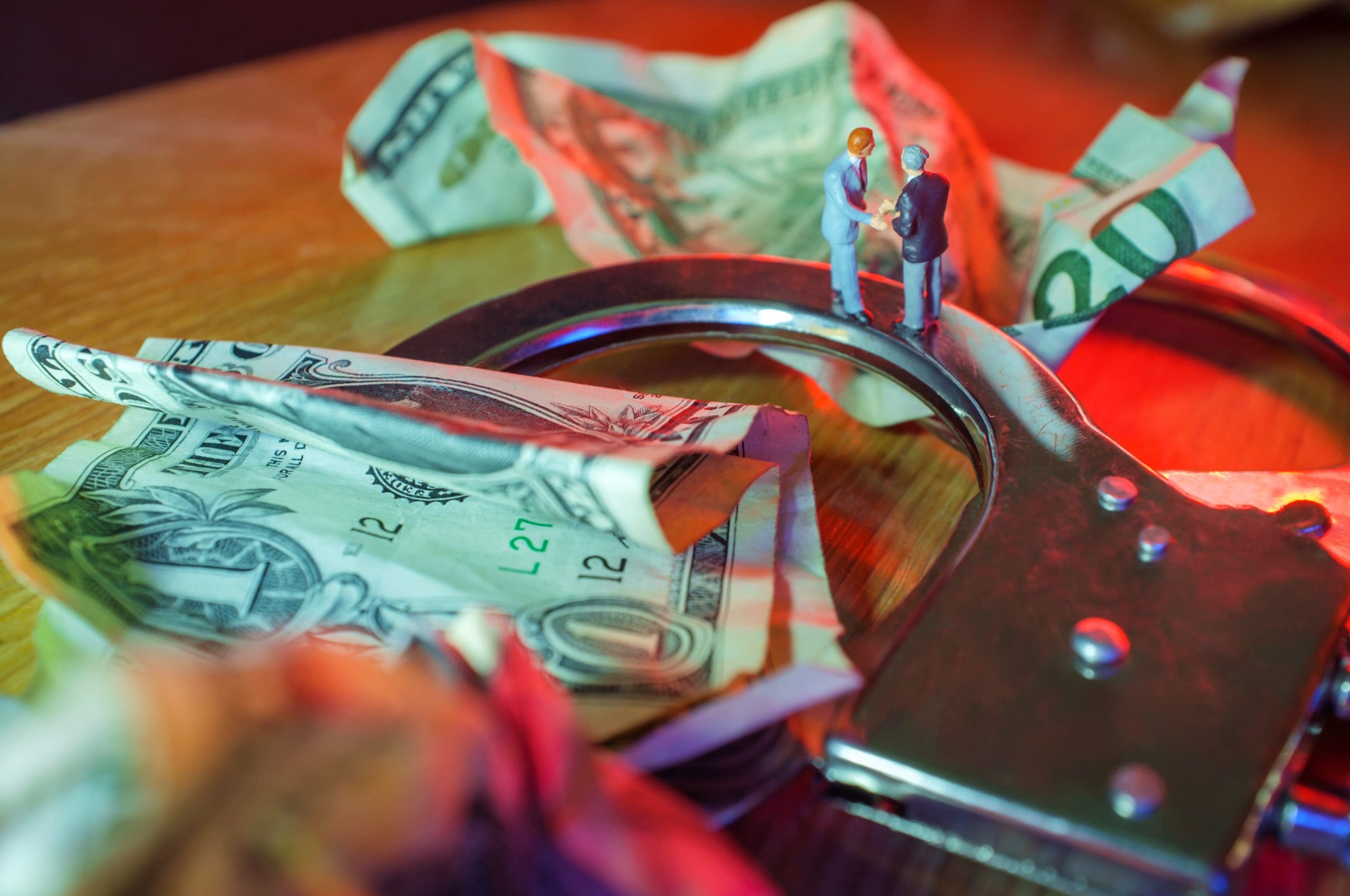 Handcuffs and money on a table.
