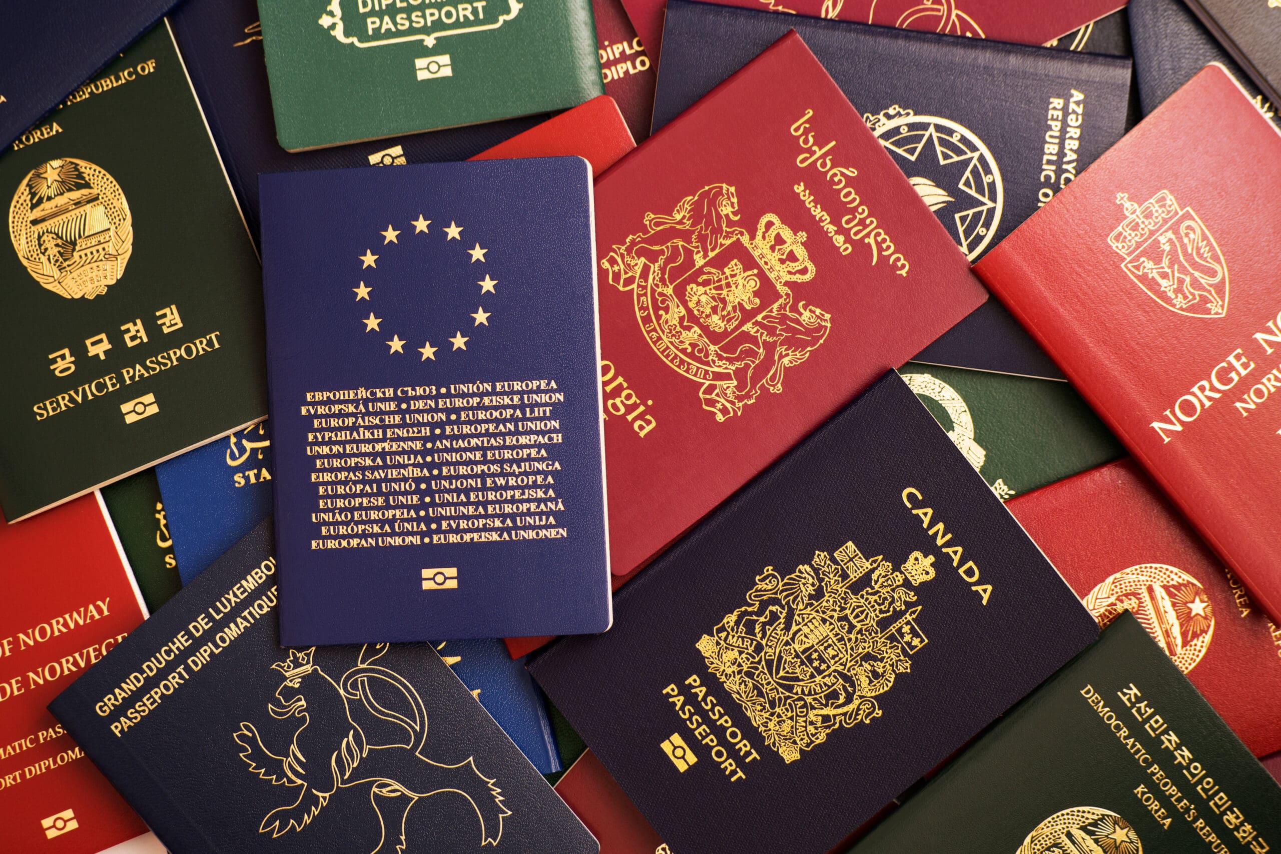 A group of passports are arranged on a table.